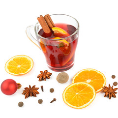 Hot red mulled wine isolated on white background with spices, orange slice, anise and cinnamon sticks. Flat lay, top view.