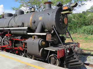 Fototapeta na wymiar Old steam locomotive in activity, in the interior of Brazil, in a railway station waiting for passengers for tourist trip.n.