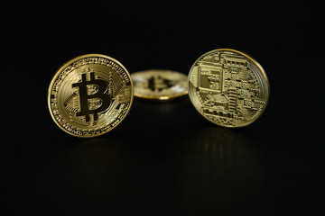 Gold Bitcoins isolated on black background