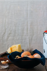 Fresh eggs and milk in a can on a wooden background. Stll life. Rustic style.
