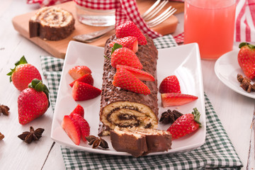 Chocolate roll with strawberries. 