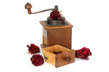 Manual coffee grinder with roses on a white background. Antiquary. Retro. Old things. Coffee
