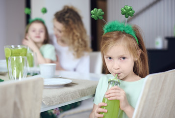 Portrait of girl drinking green cocktail.