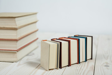 Pile of old pastel colors books stacked