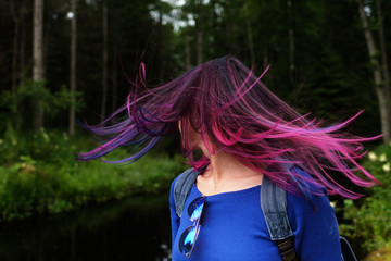 Colored blue and pink hair girl in the wind back view