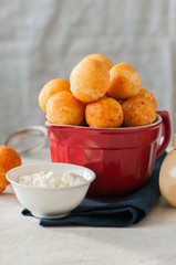 Small cottage cheese doughnuts (castgnole) in a bowl. White stone background.