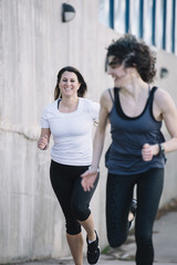 Fototapeta na wymiar two running woman in the street