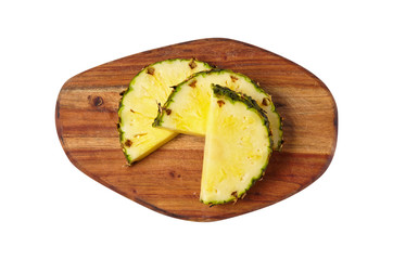 A pineapple. Useful fruit. Vitamins. He's cut. A piece. View from above. 