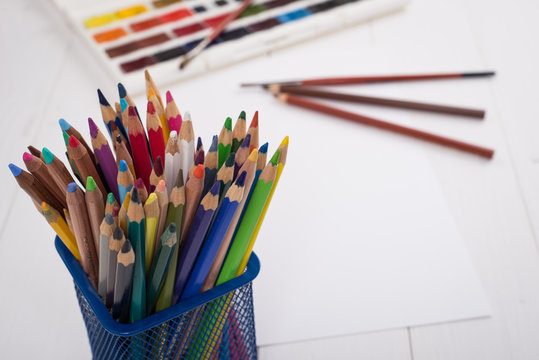 Paints, pencils and brushes on wooden to a floor. Image preprocessing
