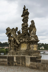 Fototapeta na wymiar Ancient sculptures at Charles Bridge in Prague. Czech Republic
