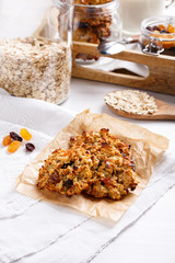 Healthy oatmeal cookies with raisins on white table.