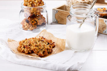 Healthy oatmeal cookies with raisins on white table.