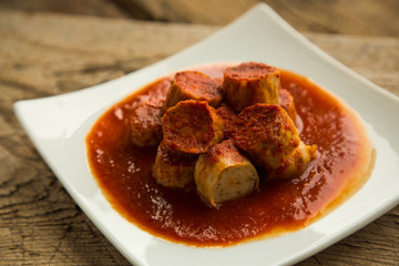 Chicken curry sausages served on plate.