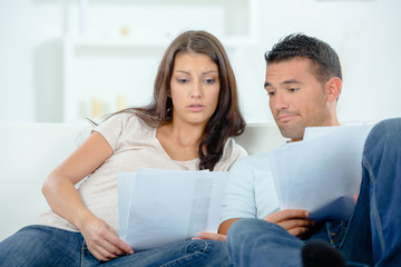 Worried couple looking at paperwork