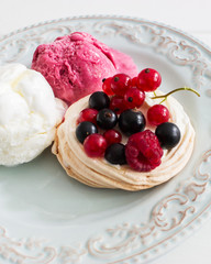 Three dessert ice cream berry pavlova nests kitchen wooden table selective focus.