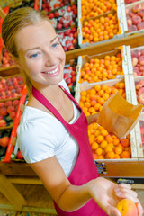 Giving an orange to a customer