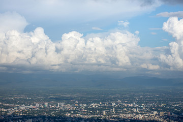 View from high on the mountain Look down Image of the city There are many buildings With blue sky...