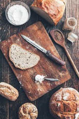 Delicious fresh bread on wooden background