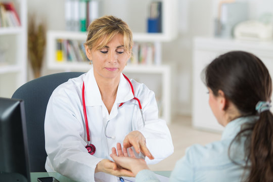 female doctor with patients hand in hers