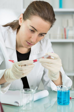 young female scientist loads samples for dna amplification