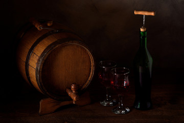  a small wooden wine bar, barrel on the legs and a wooden crane on a wooden background with a glass of wine and bottle of wine