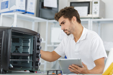 attractive repairman concentrated at work