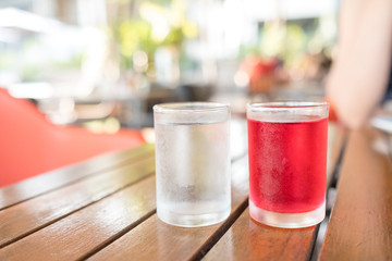 sweet drinking water in clear glass, red water, on the table