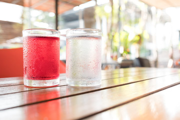 sweet drinking water in clear glass, red water, on the table
