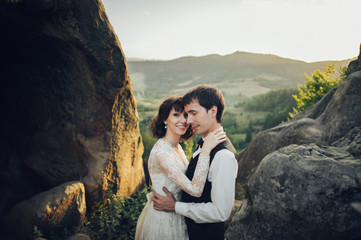 Naklejka premium Luxury wedding couple is hugging each other in mountains