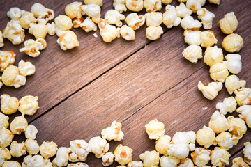 popcorn texture on a wooden table blackground