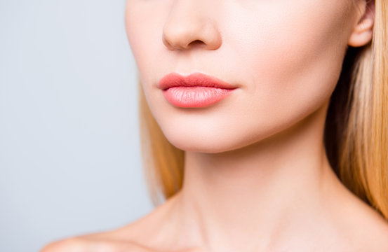 Close up cropped photo of big natural woman's lips without lipstick and perfect skin.