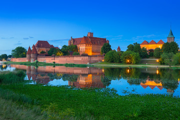 Naklejka na ściany i meble Malbork Castle of the Teutonic Order at dusk, Poland