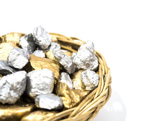 wicker tray full of gold nugget on white background, rich concept
