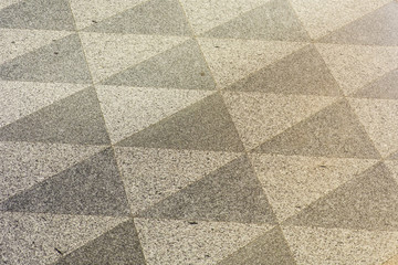 Texture of a marble floor with black and white triangular decorations.