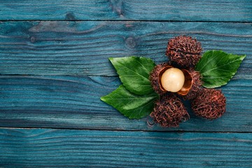 Rambutan Tropical Fruits. On a wooden background. Top view. Copy space.