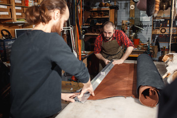 Working process in the leather workshop. Tanner in old tannery.