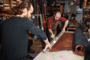 Working process in the leather workshop. Tanner in old tannery.