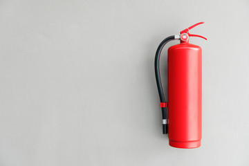 Fire extinguisher on the gray wall - 190528894