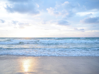 sunset on the tropical beach with beautiful sky, clouds, soft waves