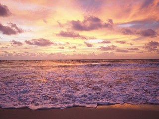 Fototapeta na wymiar Colorful sunset on the tropical beach with beautiful sky, clouds, soft waves.