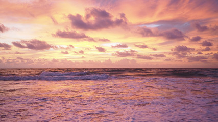 Naklejka na ściany i meble Colorful sunset on the tropical beach with beautiful sky, clouds, soft waves