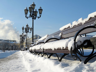 Snowy bench and street lights. Winter view of the Moscow, Manezhnaya square