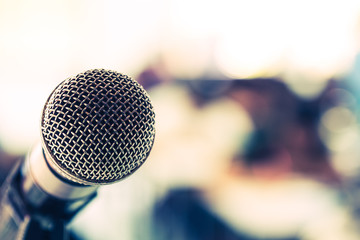 old microphone in front of seminar room, copy space on right, blue tone, education, experience and...