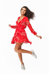 Pretty model in waving dress on white