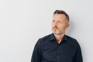 Middle-aged creative man daydreaming about future