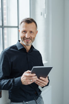 Portrait of a happy man holding a tablet PC