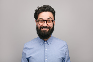 Smiling bearded man in shirt and eyeglasses