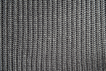 Dark gray knitting texture background or knitted pattern background. Knitting or knitted background close up view.