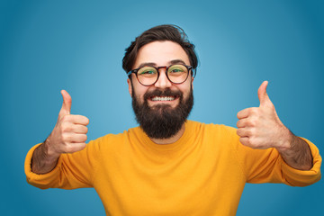 Happy hipster gesturing thumbs up