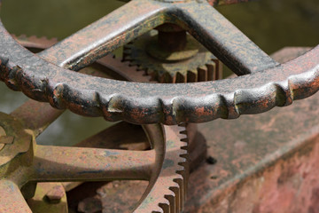 Rusty water gate mechanism with handle.